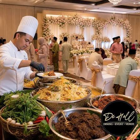 Chefs plating gourmet dishes in the KudaEmas kitchen
